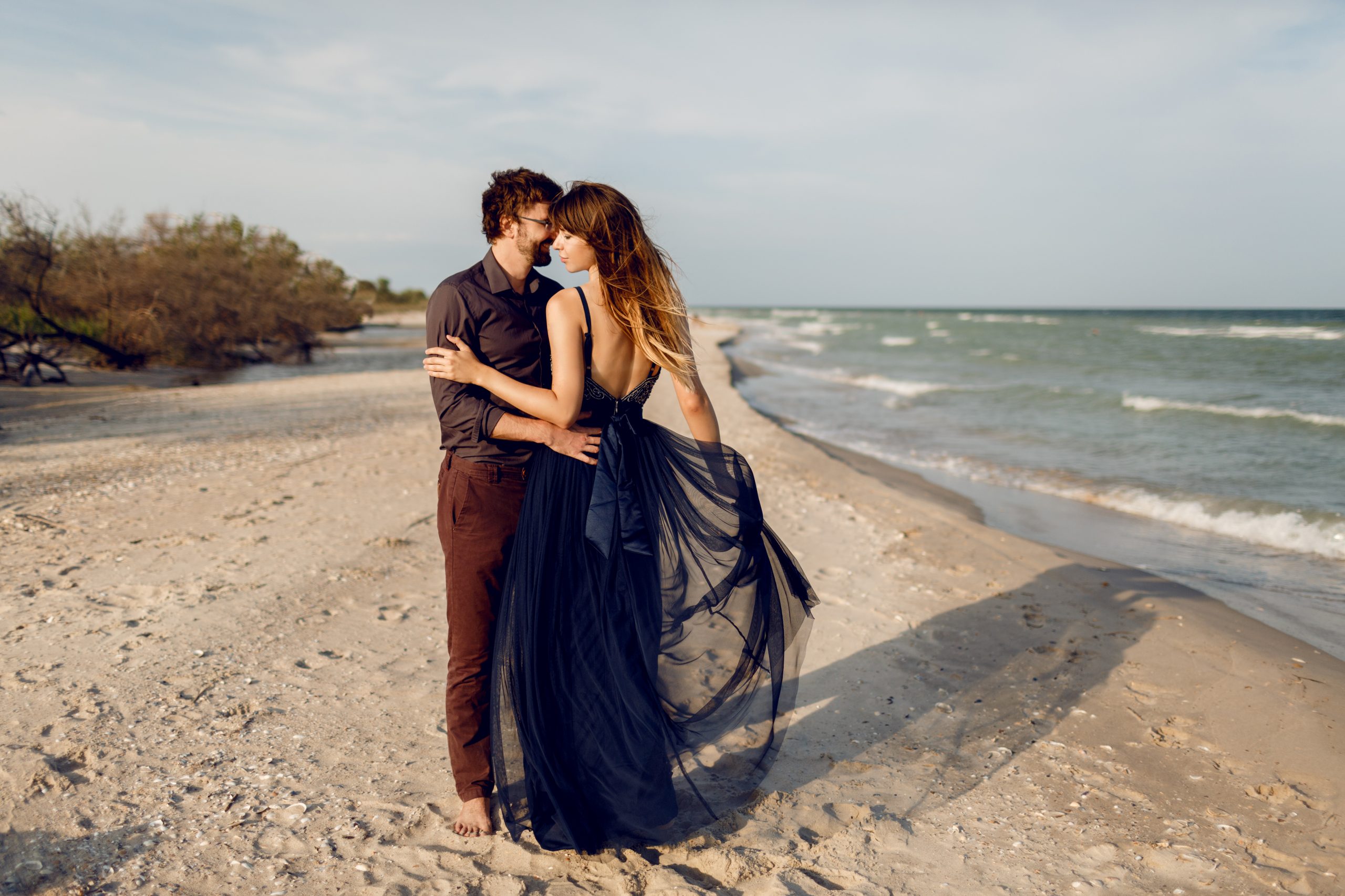 Couple enjoying honeymoon by the ocean